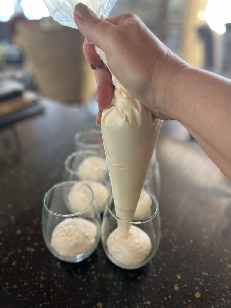 Squeezing pastry bag into glasses