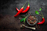 Whole red chili peppers and tricolor peppercorns