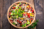 fresh quinoa salad in wooden bowl