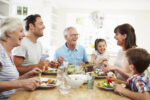 Smiling family eating together at the table