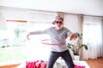 Senior man having fun with hula hoop