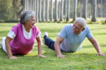 Active older couple exercising in the park
