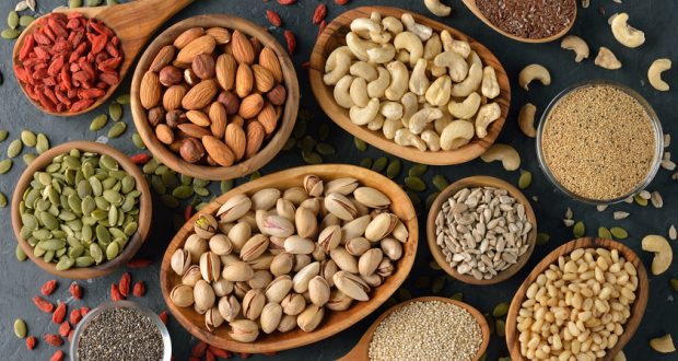 Selection of nuts and seeds in wooden bowls