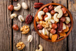 Mixed nuts in bowl on wooden table