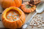 pumpkin soup served inside of a pumpkin