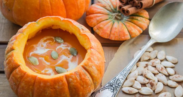 pumpkin soup served inside of a pumpkin