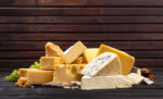 Selection of cheeses on wooden board